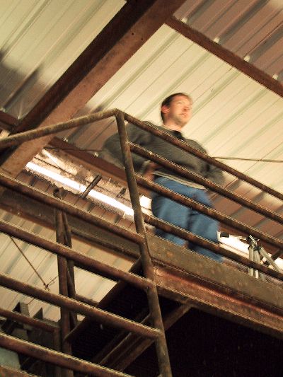 [The place where the artists hang out is a warehouse-y space that was going to be some big electromagnetic metal sorting facility. Unfortunately, it didn't work at all. So there's big metal ramps and belts and platforms, but no useful stuff. The landfill folks needed some good PR so presto, art space! Pete is not this blurry in real life.
]