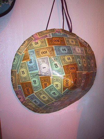 [Yes, it's a coolie hat made out of Monopoly money. Ironic, no?
]